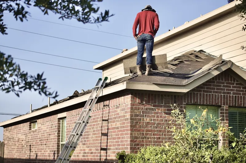 Professional roofer working on a residential roof in Southold